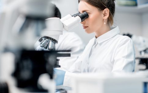 working with microscope at life sciences laboratory