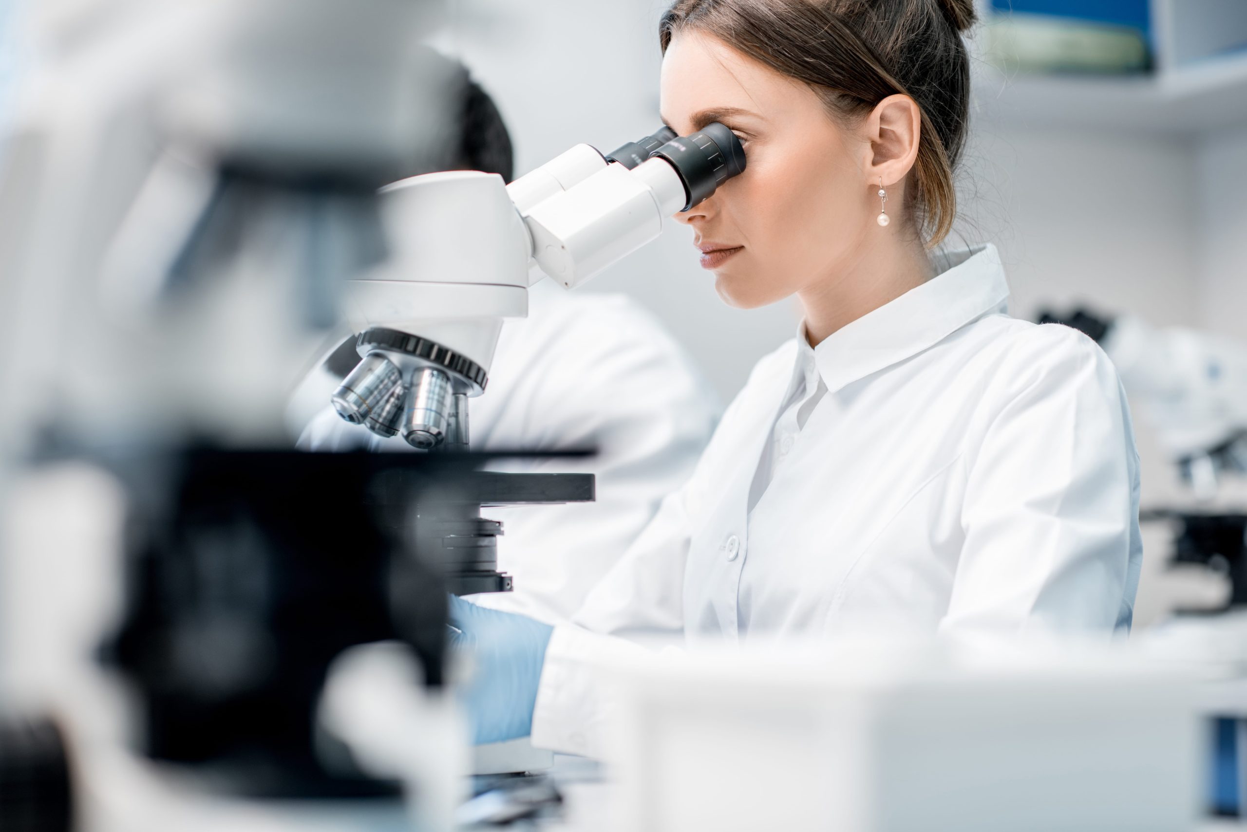 working with microscope at life sciences laboratory